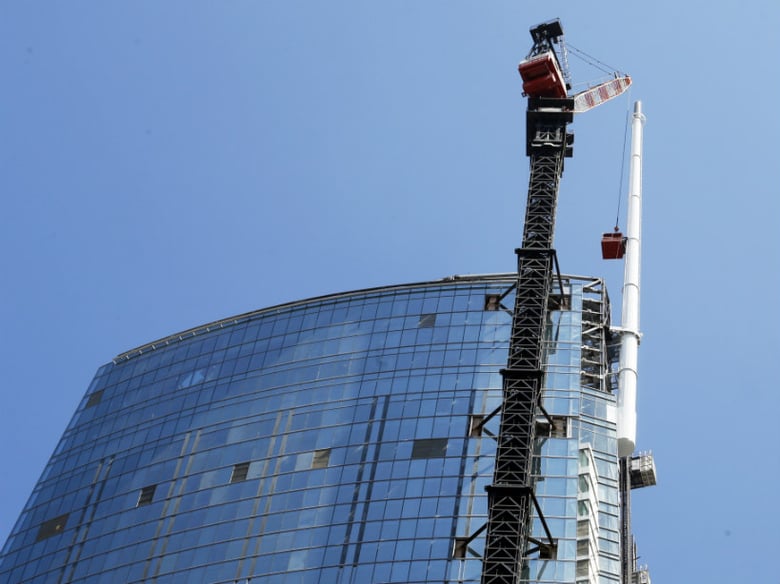 A 160-foot spire is seen atop the Wilshire Grand Tower building after a crane hoisted it into place early Saturday, Sept. 3, 2016, in downtown Los Angeles. The 10-ton spire makes the building the tallest building west of the Mississippi River.